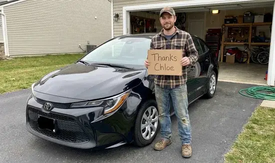 Chris B. holding a Thank You Chloe sign