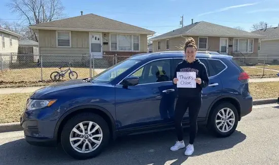 Jessica H. holding a Thank You Chloe sign