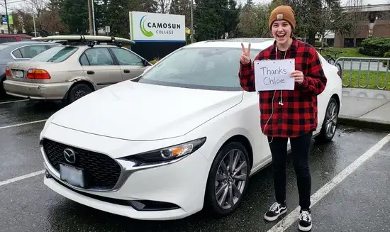 Jordan K. holding a Thank You Chloe sign