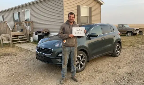 Kevin L. holding a Thank You Chloe sign