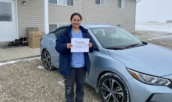 Maria G. holding a Thank You Chloe sign