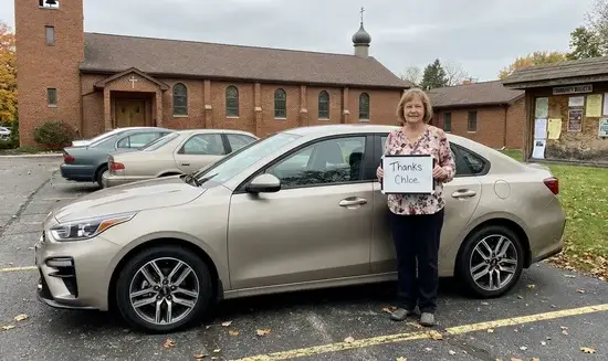 Nancy E. holding a Thank You Chloe sign