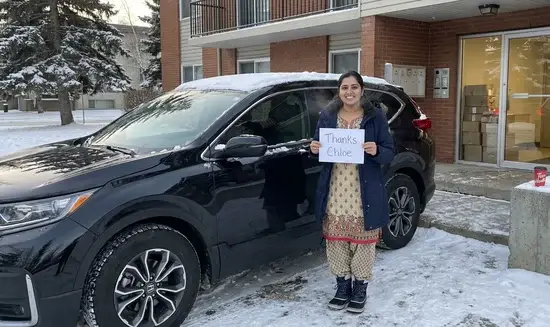 Priya S. holding a Thank You Chloe sign