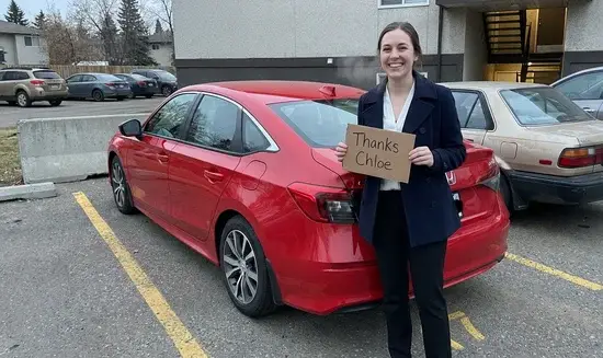 Sarah L. holding a Thank You Chloe sign